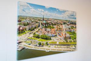 a painting of a city with a river at Aleda Kaskada in Szczecin