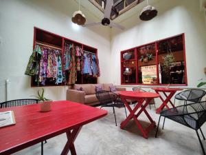 a living room with two red tables and a couch at Tumi Hostel in Kumasi