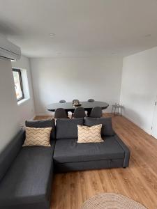 a living room with a couch and a table at Barros' House in Chaves