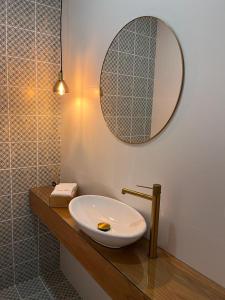 een badkamer met een wastafel en een spiegel op een aanrecht bij Barros' House in Chaves