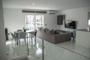 a living room with a couch and a table at Villa el Olivo in Alhaurín de la Torre