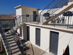 een wit gebouw met trappen en deuren en een trapleuning bij Appartement Azur in Balaruc-les-Bains