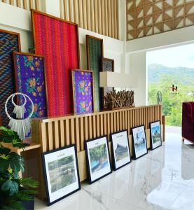 a group of framed photographs on display in a room at Hakata Lejja near Natural Hot spring in Batu-Batu