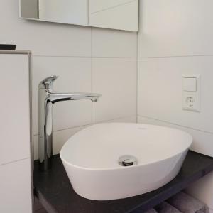 a white sink with a faucet in a bathroom at bellasBnB an der Jagst in Möckmühl