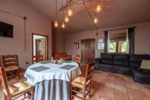 a living room with a table and a couch at Bodega Andrés Iniesta con visita y cata in Fuentealbilla