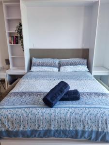 a bed with two pillows on top of it at Brand New Top Floor Studio - The Hub Gibraltar - Self Catering in Gibraltar