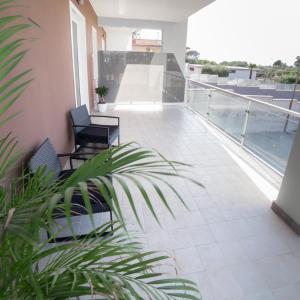 a balcony with two chairs on a building at Intimity Luxury Rooms in Qualiano