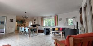 a kitchen and living room with a table and chairs at La Ginelle - Appartement Isba in Airoux
