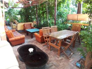 a patio with a wooden table and chairs at izmir Tatil Evi Beach Resort Seferihisar in Ürkmez