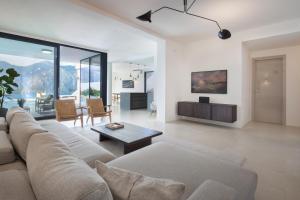a living room with a couch and a table at Residenza Dimora Privata With Pool in Malcesine