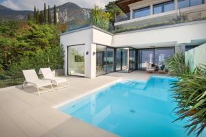 a house with a swimming pool and a patio at Residenza Dimora Privata With Pool in Malcesine