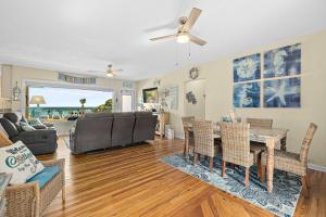 a living room with a couch and a table and chairs at Seaside Serenity Direct Oceanfront in Ormond Beach