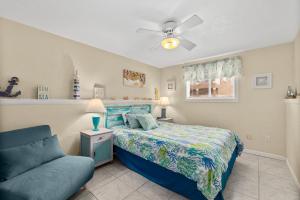 a bedroom with a bed and a couch at Seaside Serenity Direct Oceanfront in Ormond Beach