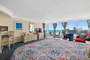 a bedroom with a large bed with a view of the ocean at Sunshine Beach Condo with Balcony Pool Hot Tub in Daytona Beach