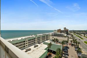 a view of the beach and the ocean from the balcony of a hotel at Sunshine Beach Condo with Balcony Pool Hot Tub in Daytona Beach