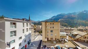 a city with buildings and mountains in the background at St. Moritzerhof 51 in St. Moritz