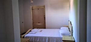a bedroom with a white bed with towels on it at Tenuta Mea in Teggiano