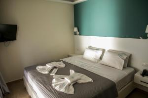 Postel nebo postele na pokoji v ubytování HOTEL ALEXANDER