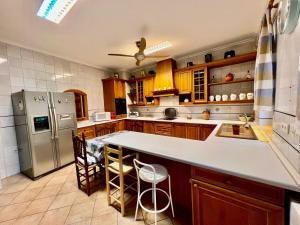 a kitchen with a refrigerator and a counter top at Casa Los Canos in Úbeda