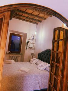 a bedroom with a large bed with a wooden frame at Giardino sul Lago con vasca Idromassaggio Jacuzzi in Castel Gandolfo