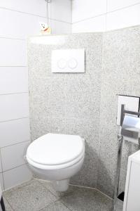 a bathroom with a white toilet in a stall at Marstall Apartmenthaus Kassel in Kassel