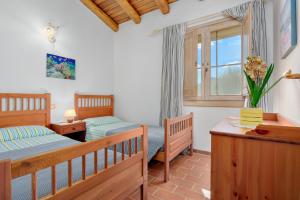 una camera da letto con due letti e una finestra di Casa Mare e Monti a Cannigione