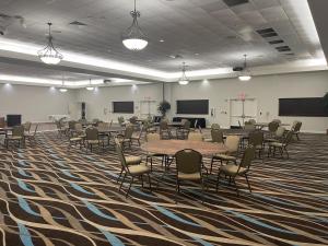 a large room with tables and chairs in it at Driftwood Dreams at the Beach in Daytona Beach