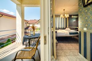 a balcony with a view of a bedroom and a bed at Plexus by DON in Eforie Sud +118 photos