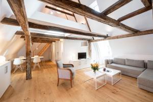 a living room with a couch and a table at Johannis Suite - Schrangen-Suites-1389 in Lüneburg