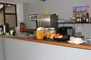 a bar with a counter top with food and drinks at Soul Hostel Av Paulista Bela Vista 1 in Sao Paulo