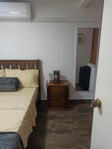 a bedroom with a bed and a dresser and a mirror at VILLAS DEL PALMAR APTO 406 in Santa Marta