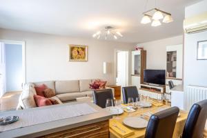 een woonkamer met een tafel en een bank bij Luxurious apartment in the heart of Zagreb in Zagreb