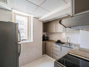 a kitchen with stainless steel appliances and a window at Noble looking 2 Bed only five minutes to Metro in Dubai