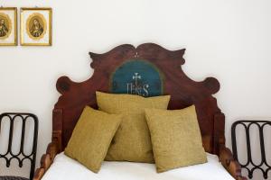a wooden headboard of a bed with yellow pillows at Appartement im Grünweinhof in Montagna