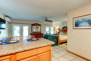 a kitchen and living room with a couch and a bed at Good Old Days Cottage King Bed Pet Friendly in Daytona Beach