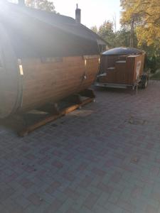 a wooden boat and a trailer on a patio at Apartamenti pie Lienes in Gardene