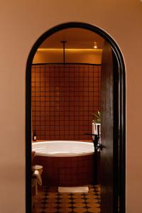 a bath tub in a bathroom through a doorway at Casa Hoyos - Hotel Boutique in San Miguel de Allende