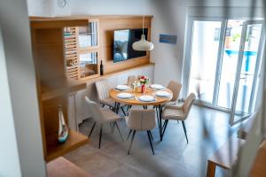 a dining room with a table and chairs at Holiday house Mareta - outdoor swimming pool, 4 bedrooms, WIFI in Jadrija