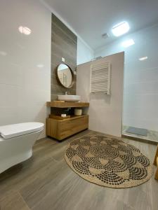 a bathroom with a sink and a toilet and a mirror at Pombal Suite in Pombal +46 photos