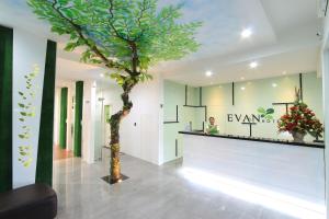 a tree in the middle of a lobby at Evan Hotel Jambi in Jambi