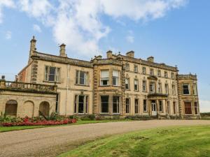 a large stone house with a driveway in front of it at No 1 Pepper Arden in Northallerton