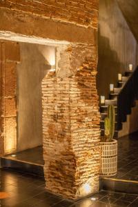 a brick wall in a room with a staircase at Casa Hoyos - Hotel Boutique in San Miguel de Allende