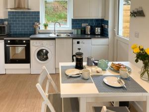 a kitchen with a table and a sink at Sonas in Torlundy