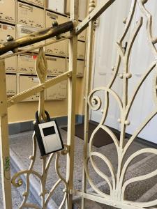 a metal gate with a cell phone plugged into it at Adorable, cosy apartment at the Heroes' Square Budapest in Budapest