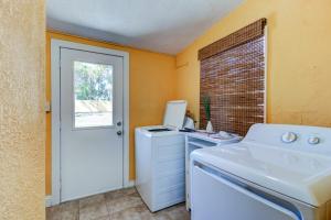 a laundry room with a washing machine and a window at The Gypsy Mermaid 3 Bed Ginormous Yard in Daytona Beach