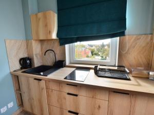 a kitchen with a sink and a window at Apartment for 2 persons right by the sea, Ustronie Morskie in Ustronie Morskie
