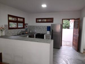 a kitchen with a refrigerator and a counter top at Casa Teodoro!!! in Trairi +29 photos