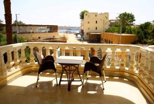 a table and chairs on top of a balcony at Egypt sun accommodation Spiritualities in Luxor