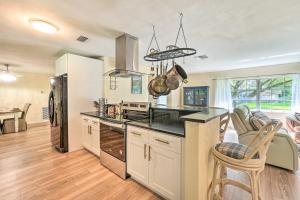 a kitchen with a refrigerator and a counter top at 4 Bedroom Clearwater Vacation Home with Amazing Backyard in Clearwater