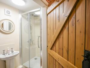 a bathroom with a shower and a toilet and a sink at Garth Ucha in Llanyblodwel